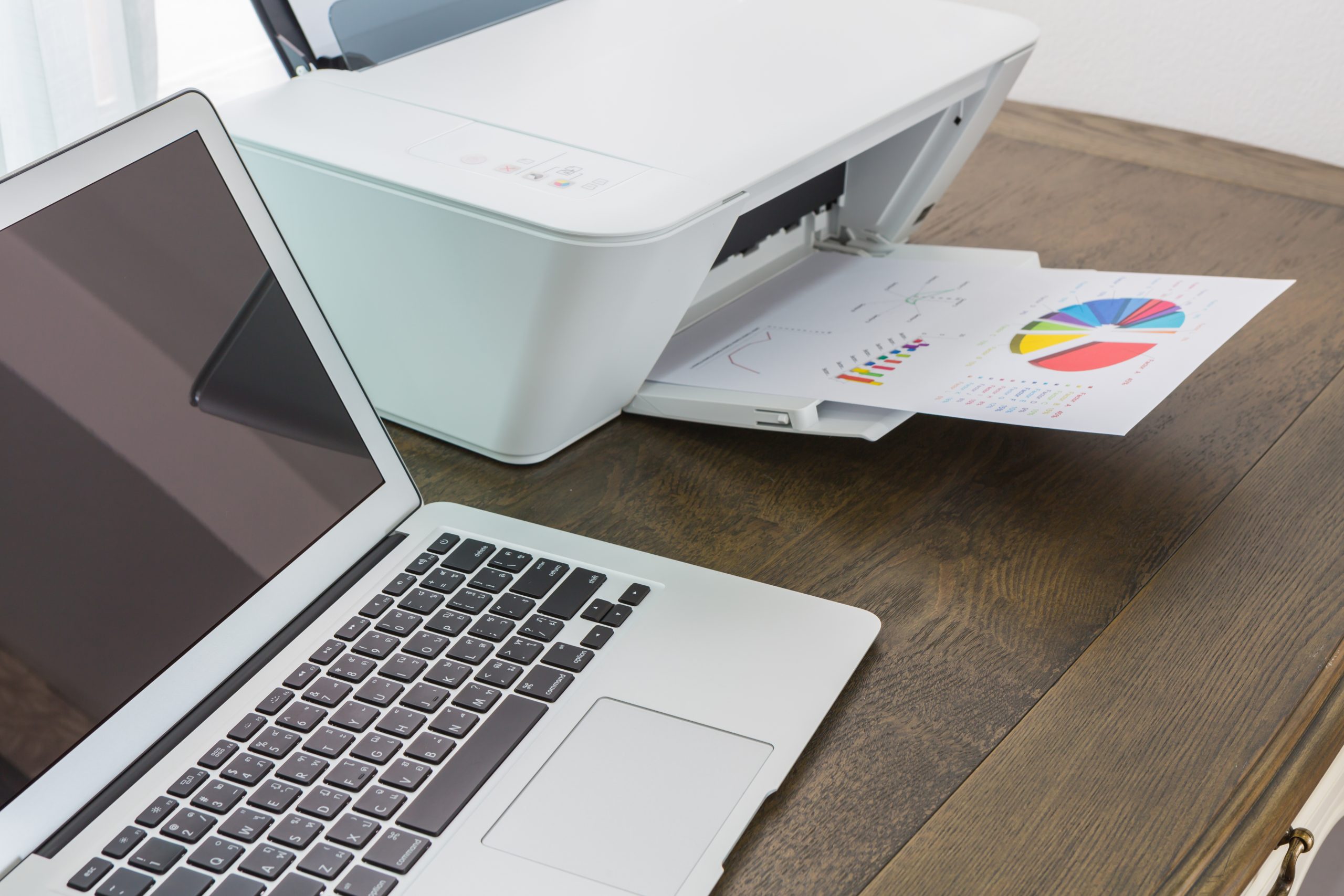 printer and Laptop on wood table